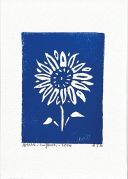 A blue linocut of a sunflower. The sunflower is white and all around it is blue.